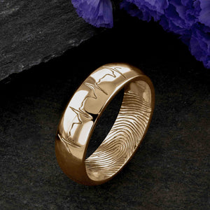 An 18ct gold Wedding Ring with a single fingerprint engraved on the inside surface | Engraved with a real heartbeat trace on the outside of the ring | Hand engraving | Men's 6mm wide, comfort court profile ring | Custom personalised wedding jewellery | Sophia Alexander Fingerprint Jewellery | Handmade in Suffolk UK