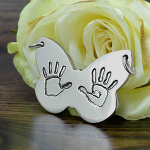 Large butterfly shaped Pendant in solid silver with two children's handprints | Personalised Gift shown on a keyring with a chain | Sophia Alexander Fingerprint Jewellery | Handmade in Suffolk UK