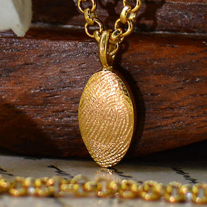 Gold Dainty Oval Fingerprint Necklace in solid 18ct gold | Displayed on an 18ct gold belcher or rolo chain | Custom engraving on reverse | Personalised Necklace | Sophia Alexander Fingerprint Jewellery | Handmade in Suffolk UK