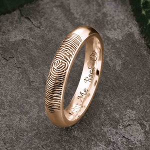A unique rose Gold Wedding Ring with an engraved fingerprint on the outer surface | Engraved with a funny personal message on the inside of the ring | The engraving reads "Put Me Back On" | Contemporary dark laser engraving | Ladies slim 4mm wide, comfort court profile ring | Custom personalised wedding jewellery | Sophia Alexander Fingerprint Jewellery | Handmade in Suffolk UK