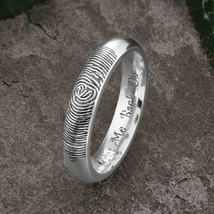 A unique white Gold Wedding Ring with an engraved fingerprint on the outer surface | Engraved with a funny personal message on the inside of the ring | The engraving reads "Put Me Back On" | Contemporary dark laser engraving | Ladies slim 4mm wide, comfort court profile ring | Custom personalised wedding jewellery | Sophia Alexander Fingerprint Jewellery | Handmade in Suffolk UK