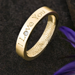 A Gold Wedding Ring with an engraved fingerprint on the inner surface | Engraved with the words "I Love You" on the outside of the ring | A single diamond set into the "o" of Love | Hand engraving | Ladies slim 4mm wide, comfort flat court profile ring | Custom personalised wedding jewellery | Sophia Alexander Fingerprint Jewellery | Handmade in Suffolk UK