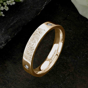 A Gold Wedding Ring with an engraved fingerprint on the outer surface | Set with two diamonds that frame the fingerprint | Hand engraving | Ladies slim 4mm wide, comfort flat-court profile ring | Custom personalised wedding jewellery | Sophia Alexander Fingerprint Jewellery | Handmade in Suffolk UK
