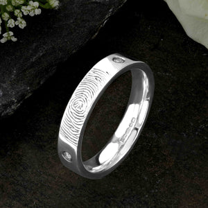 A White Gold Wedding Ring with an engraved fingerprint on the outer surface | Set with two diamonds that frame the fingerprint | Hand engraving | Ladies slim 4mm wide, comfort flat-court profile ring | Custom personalised wedding jewellery | Sophia Alexander Fingerprint Jewellery | Handmade in Suffolk UK