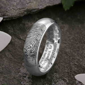 A unique White Gold Wedding Ring with an engraved fingerprint on the outer surface | Engraved with personalised wedding vows on three lines on the inside of the ring | Contemporary Laser engraving | Mens 6mm wide, comfort court profile ring | Custom personalised wedding jewellery | Sophia Alexander Fingerprint Jewellery | Handmade in Suffolk UK
