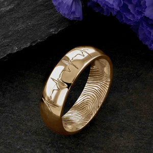 An 18ct gold Wedding Ring with a single fingerprint engraved on the inside surface | Engraved with a real heartbeat trace on the outside of the ring | Hand engraving | Men's 6mm wide, comfort court profile ring | Custom personalised wedding jewellery | Sophia Alexander Fingerprint Jewellery | Handmade in Suffolk UK