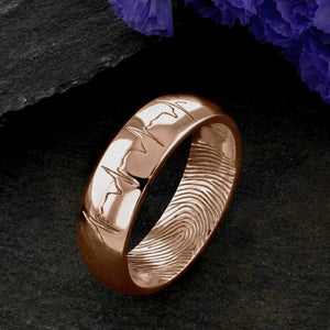 An 18ct rose gold Wedding Ring with a single fingerprint engraved on the inside surface | Engraved with a real heartbeat trace on the outside of the ring | Hand engraving | Men's 6mm wide, comfort court profile ring | Custom personalised wedding jewellery | Sophia Alexander Fingerprint Jewellery | Handmade in Suffolk UK