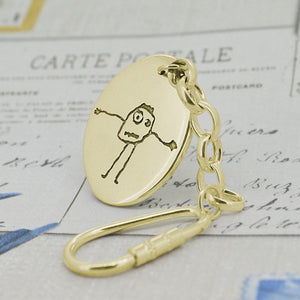 Large oval shaped Pendant in solid gold with a child's real drawing or special picture | Personalised Gift shown on a keyring with a chain | Sophia Alexander Fingerprint Jewellery | Handmade in Suffolk UK