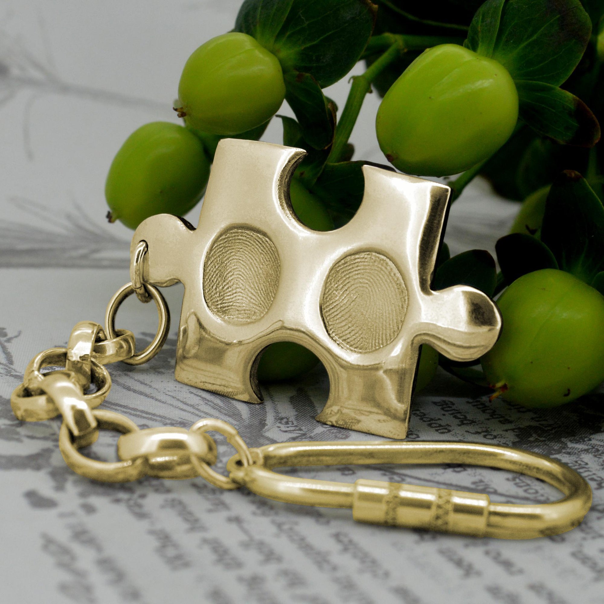 Solid Gold puzzle piece style pendant with two children's fingerprints | Shown on a keyring with a chain | Personalised Gifts | Sophia Alexander Fingerprint Jewellery | Handmade in Suffolk UK