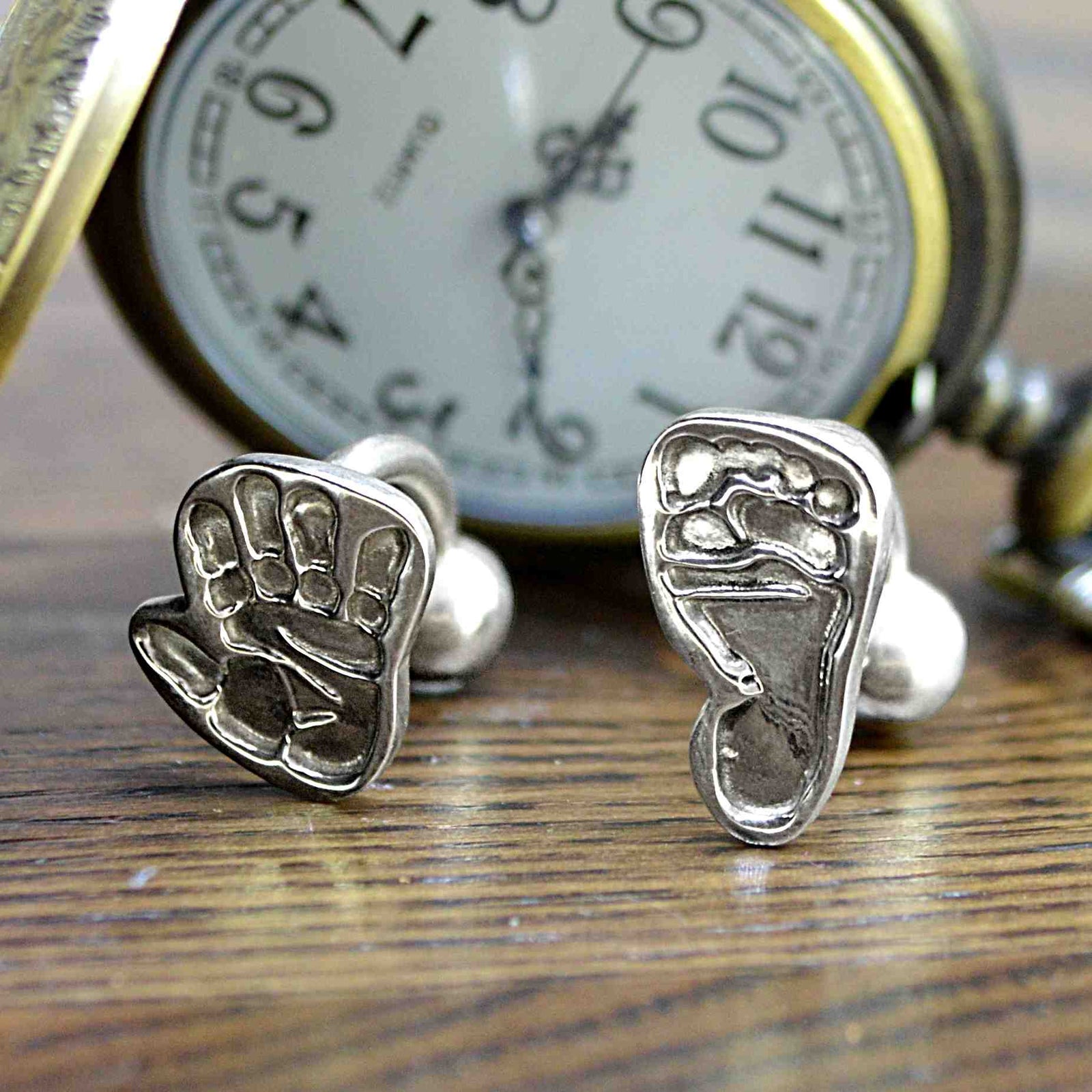 Two shaped cufflinks in solid silver featuring one child's handprint and one footprint | Solid Cufflink backs | Custom Personalised Gift | Sophia Alexander Fingerprint Jewellery | Handmade in Suffolk UK