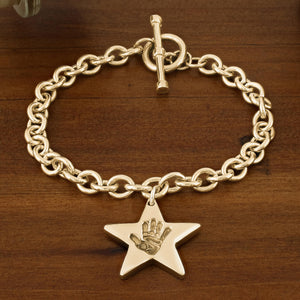 GOLD TOGGLE T-BAR BRACELET WITH HAND PRINT STAR CHARM